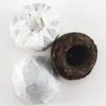 Pu-erh Tuo Cha Chinese black tea in compact mini tea cake form on white background